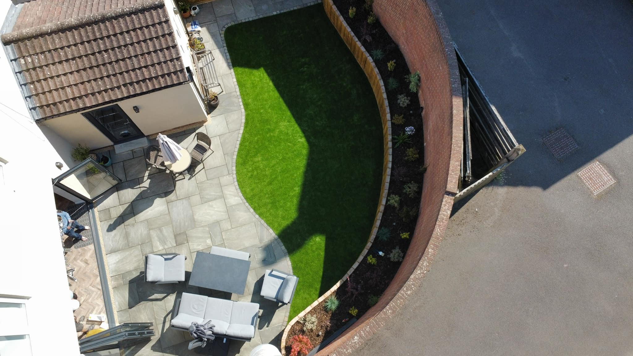 Stunning aerial view of a completed patio and garden transformation by Maximised