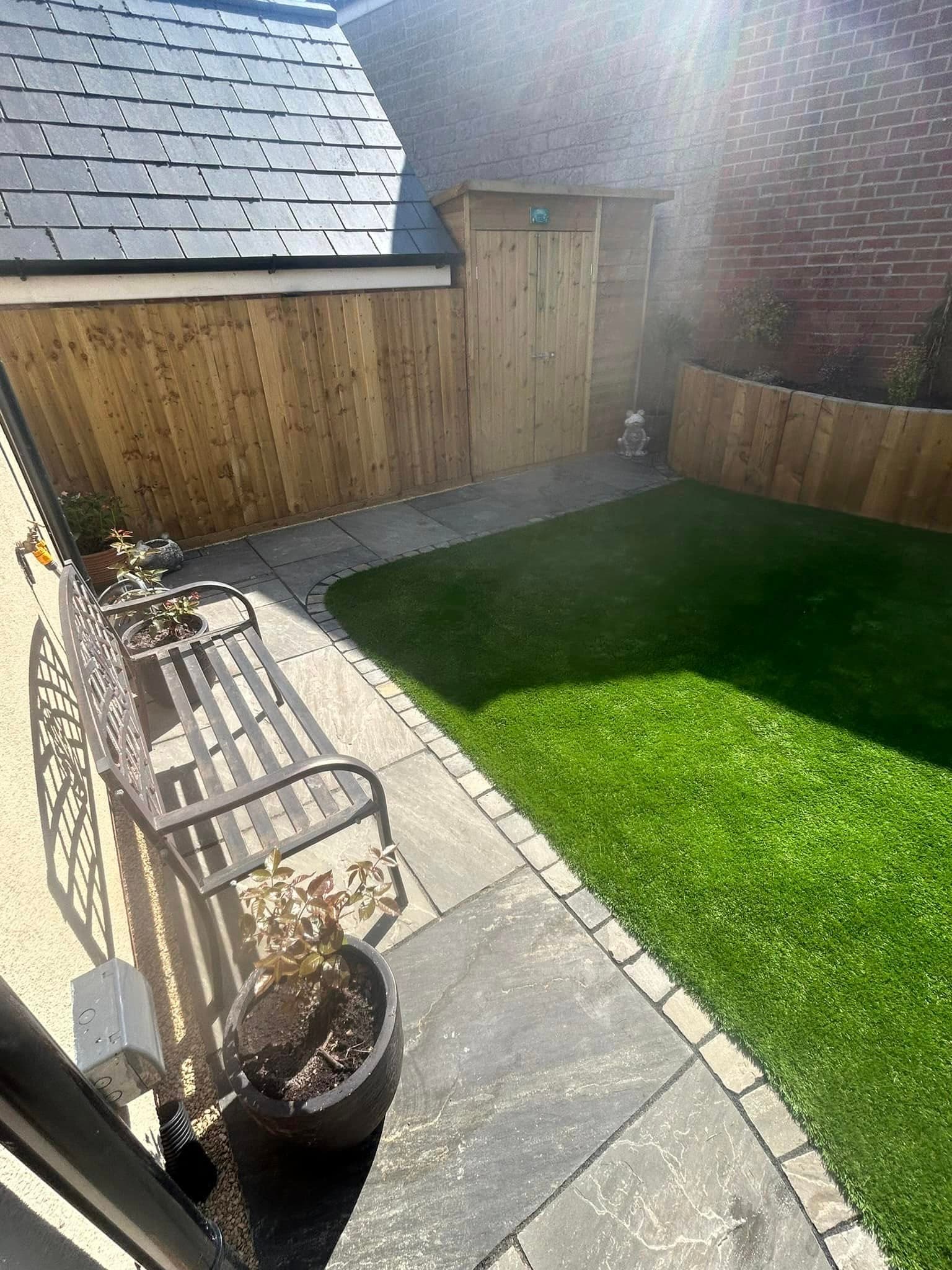 Patio with artificial grass and shed