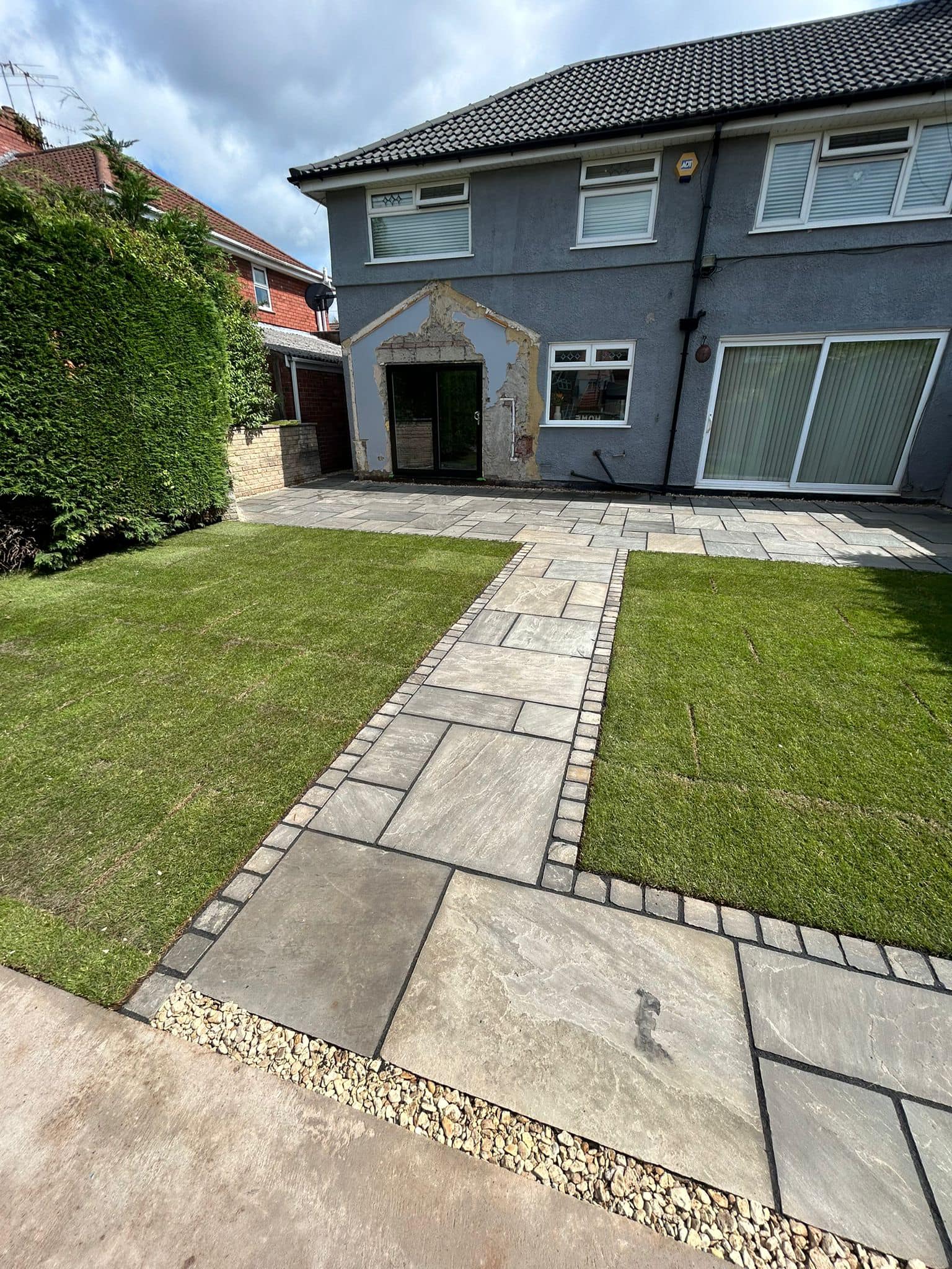 Front garden transformation with patio path and fresh turf